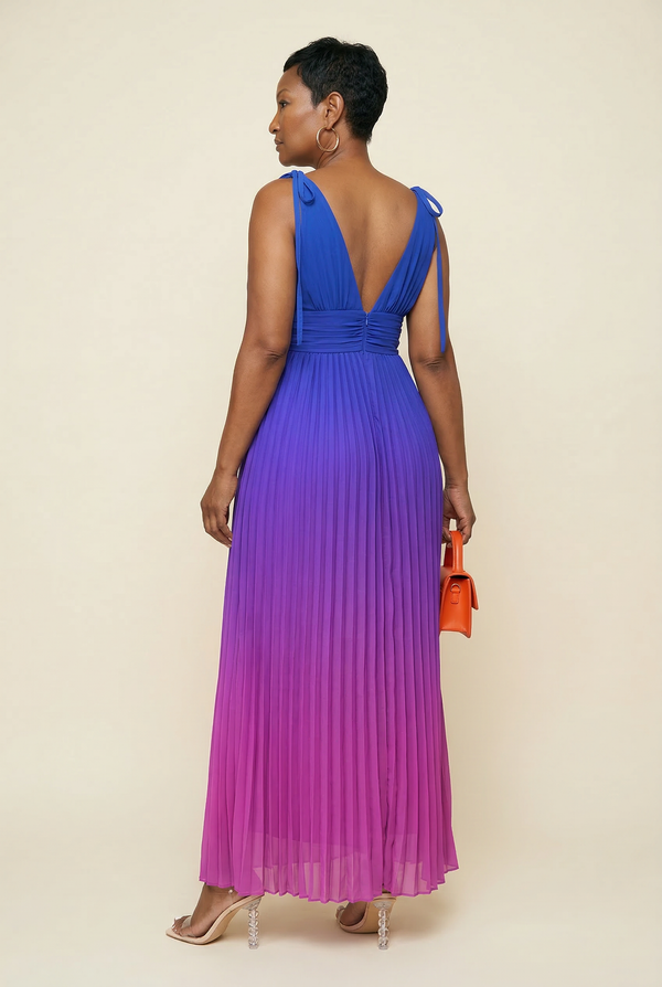 Woman wearing a blue to purple gradient dress with a plain background
