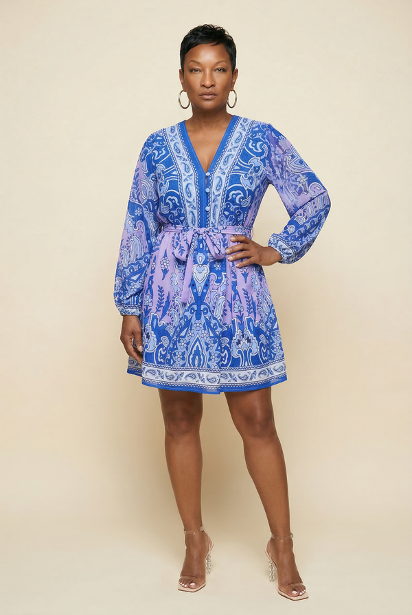 Woman wearing a blue patterned dress against a beige background
